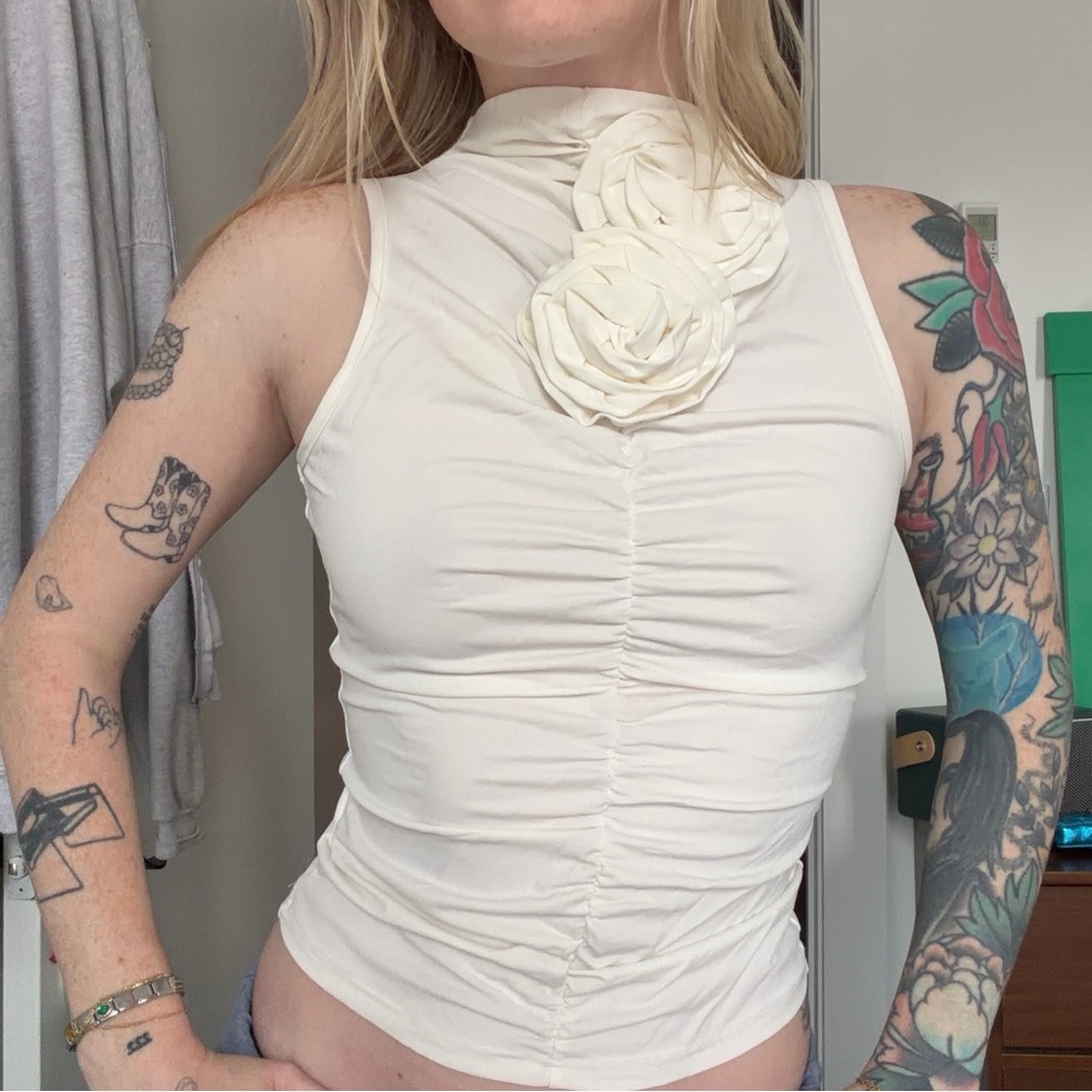white tank top with floral appliqué